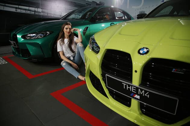 June 30, 2021, Jakarta, Jakarta, Indonesia: Models pose between The All New BMW M3 and M4 Competition cars after a virtual launch in Jakarta, June 30, 2021. BMW Indonesia launched the two cars with three new colors, a high-performance 510hp 650Nm engine, and an expressive design as well as an eight-speed BMW M Steptronic transmission with Drivelogic and a series of innovative technologies developed by BMW M that will be offered for The new BMW M3 Competition with the price of IDR 2,059 billion off the road, while the New BMW M4 Competition Coupe will be offered at a price of IDR 2.119 billion off the road. Jakarta Indonesia - ZUMAr173 20210630_zip_r173_014 Copyright: xDasrilxRoszandix