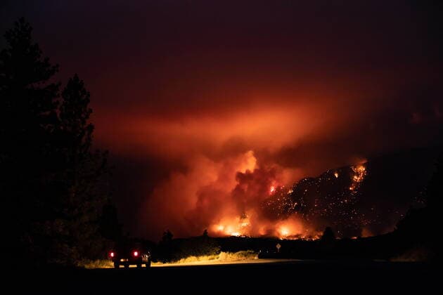 July 1, 2021, Lytton, BC, Canada: A motorist watches from a pullout on the Trans-Canada Highway as a wildfire burns on the side of a mountain in Lytton, B.C., Thursday, July 1, 2021. Lytton Canada  - ZUMAc35_ 20210701_zaf_c35_319 Copyright: xDarrylxDyckx