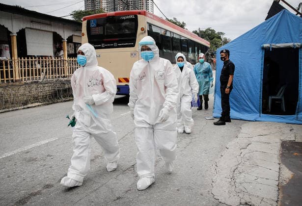 July 3, 2021, Kuala Lumpur, Malaysia: Health workers dressed in protective suits arrive at the Segambut Dalam housing area which was placed under the enhanced movement control order (EMCO) due to surge in the number of COVID-19 daily cases recorded..Malaysia government starts to further tighten the movement control and imposes lockdown in state of Selangor and parts of Kuala Lumpur, due to the daily high number of coronavirus infections cases reported. Kuala Lumpur Malaysia - ZUMAs197 20210703_zaa_s197_001 Copyright: xWongxFokxLoyx