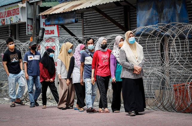 July 3, 2021, Kuala Lumpur, Malaysia: People wearing masks walk in line to go for Covid-19 swab testing at the Segambut Dalam housing area which was placed under the enhanced movement control order (EMCO) due to surge in the number of COVID-19 daily cases recorded..Malaysia government starts to further tighten the movement control and imposes lockdown in state of Selangor and parts of Kuala Lumpur, due to the daily high number of coronavirus infections cases reported. Kuala Lumpur Malaysia - ZUMAs197 20210703_zaa_s197_012 Copyright: xWongxFokxLoyx