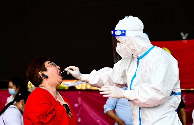 (210705) -- RUILI, July 5, 2021 -- A medical worker collects a swab sample for nucleic acid test in Ruili City of southwest China s Yunnan Province, on July 5, 2021. Ruili City on Monday imposed entry and exit restrictions after the emergence of new COVID-19 cases. The city reported three new locally transmitted confirmed COVID-19 cases on Sunday. Authorities have asked people to refrain from entering or leaving the city unless necessary. ) CHINA-YUNNAN-RUILI-COVID-19-TEST (CN) WangxGuansen 