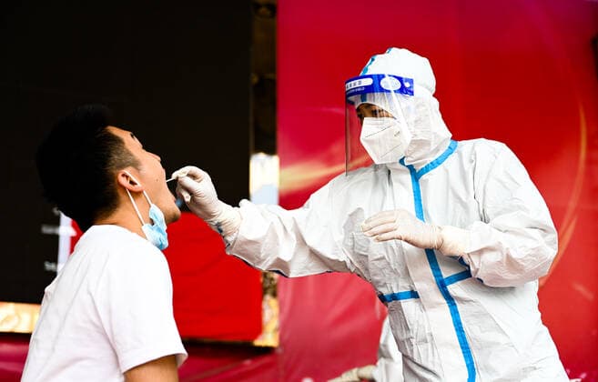 (210705) -- RUILI, July 5, 2021 -- A medical worker collects a swab sample for nucleic acid test in Ruili City of southwest China s Yunnan Province, on July 5, 2021. Ruili City on Monday imposed entry and exit restrictions after the emergence of new COVID-19 cases. The city reported three new locally transmitted confirmed COVID-19 cases on Sunday. Authorities have asked people to refrain from entering or leaving the city unless necessary. ) CHINA-YUNNAN-RUILI-COVID-19-TEST (CN) WangxGuansen 