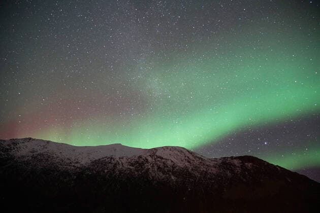 Creative Highlights World Spectacular green and pink Northern Lights in Tromso Copyright: xMariannaxJaszczukx Model Released