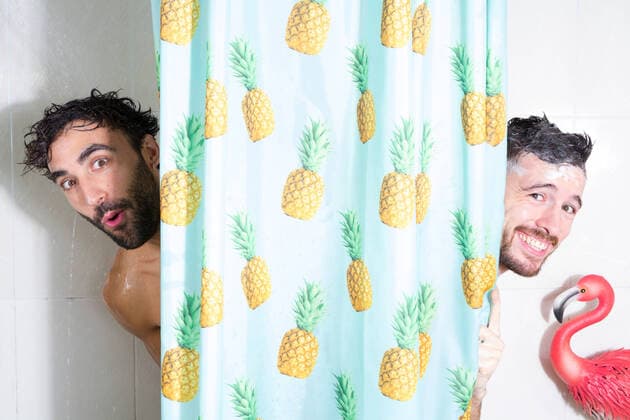 Creative Highlights Symbolbilder Cheerful adult bearded homosexual boyfriends with wet hair and soap foam looking out curtain while taking shower together, Model released Copyright: xSheyxNunezx MR
