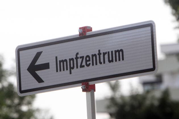 Wegweiser mit Richtungspfeil und Aufschrift Impfzentrum steht in der Innenstadt von Heidelberg, Baden Württemberg, Deutschland