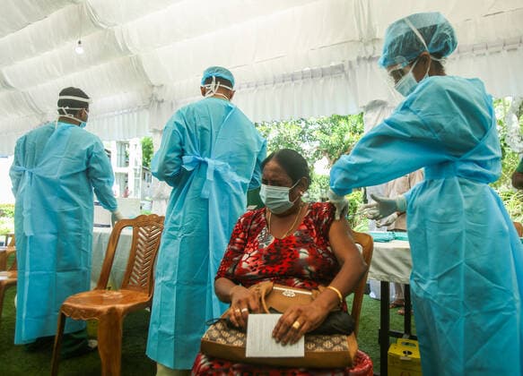July 7, 2021, colombo, Sri Lanka: A Sri Lankan Army Medical officer administers a dose of Pfizer-BioNTech COVID-19 Vaccine to an elderly woman at Army Hospital vaccination site in Colombo, Sri Lanka, July 7, 2021. Sri Lankan health authorities on Wednesday began rolling out doses of the Pfizer vaccine for those who have received only the first dose of the AstraZeneca vaccine. colombo Sri Lanka. - ZUMAd152 20210707_znp_d152_002 Copyright: xPradeepxDambaragex