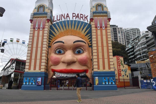 NSW COVID19 LOCKDOWN RESTRICTIONS, A pedestrian walks past the Luna Park in Sydney, Saturday, July 10, 2021. Tough new restrictions are now in place for Greater Sydney after another spike in COVID-19 cases. ( NO ARCHIVING, EDITORIAL USE ONLY, NO USE IN BOOKS WITHOUT CONSENT SYDNEY NSW AUSTRALIA  Copyright: xMICKxTSIKASx 20210710001556199295