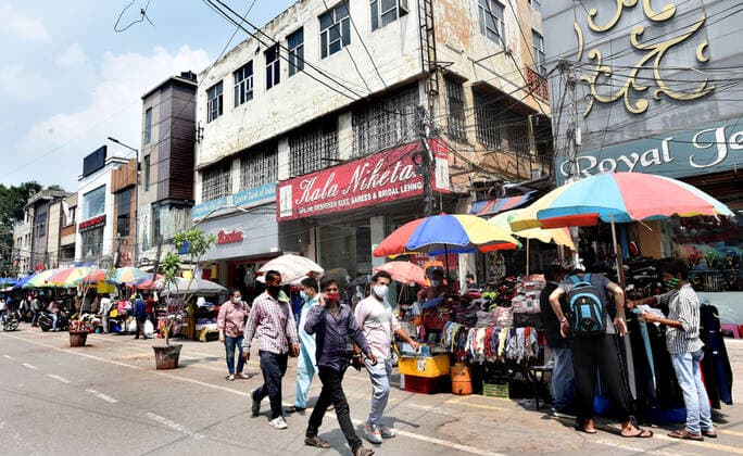 NEW DELHI, INDIA ? JULY 10: People shopping at footpath market near the closed shops after the Delhi Disaster Management Authority (DDMA) on Friday ordered temporary closure of Gaffar Market and Naiwala Market in central Delhi?s Karol Bagh -- popular for car accessories and electronic gadgets -- for at least two days, citing violation of Covid-19 regulations, on July 10, 2021 in New Delhi, India. In the last 10 days, the authorities have similarly cracked down on at least nine such popular markets in the city, including the Lajpat Nagar Central Market and Laxmi Nagar market. (Photo by Sonu Mehta Hindustan Times ) Two Karol Bagh Markets Temporarily Closed Over Violation Of Covid Norms