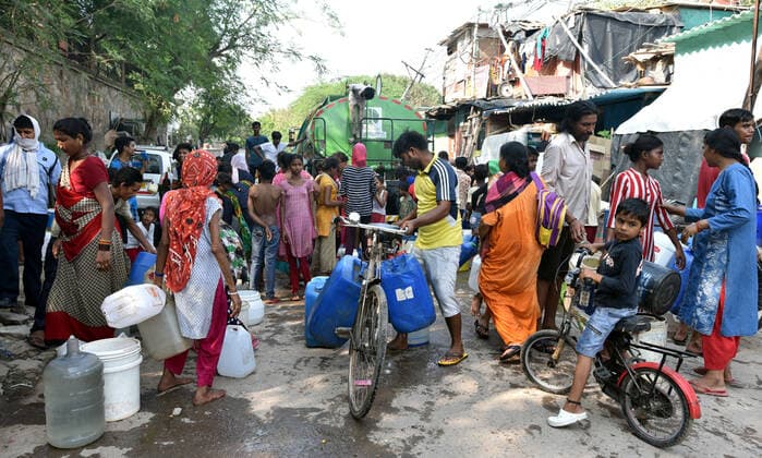 NEW DELHI, INDIA ? JULY 10: People gather to collect drinking water from a tanker in Sanjay camp, Chanakyapuri, on July 10, 2021 in New Delhi, India. The Aam Aadmi Party MLA said Haryana has been supplying about 100 million gallons less water per day, which has led to water crisis in NDMC areas, central, south, and west Delhi. (Photo by Sonu Mehta Hindustan Times ) Water Crisis In Delhi