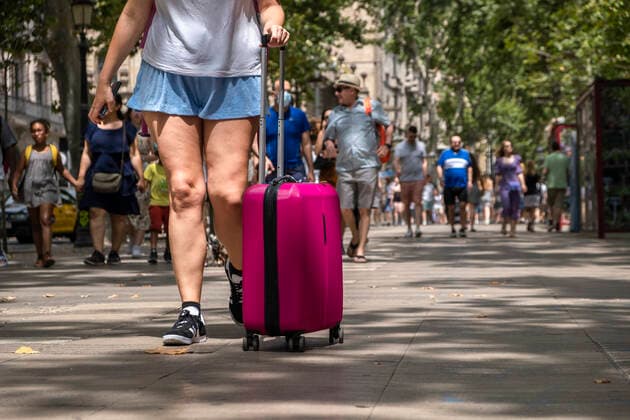 July 11, 2021, Barcelona, Spain: A person is seen carrying a rolling suitcase down the popular Rambla in Barcelona..Barcelona suffers the effects of the fifth wave of the coronavirus with more than 8,000 new cases in the last 24 hours, predominantly of the delta variant. New restrictive measures will be taken in the next few hours. Barcelona Spain - ZUMAs197 20210711_zaa_s197_236 Copyright: xPacoxFreirex