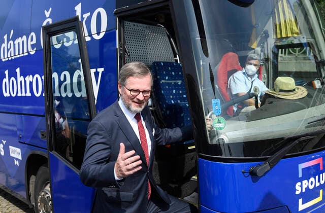 ODS chairman Petr Fiala poses in front of electoral bus of coalition Together (ODS, TOP 09, KDU-CSL) during the press conference on its summer election campaign in Prague, Czech Republic, July 13, 2021. (CTKxPhoto MichalxKrumphanzl) CTKPhotoP2021071303076  kru 3