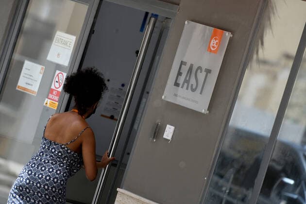 (210713) -- ST JULIAN S, July 13, 2021 -- A student walks into an English language school in St Julian s, Malta, on July 13, 2021. Starting from July 14, Malta will once again close its English language teaching schools after most of the new cases were students who traveled to Malta to learn English. (Photo by Xinhua) MALTA-ST JULIAN S-COVID-19-MEASURES JonathanxBorg 