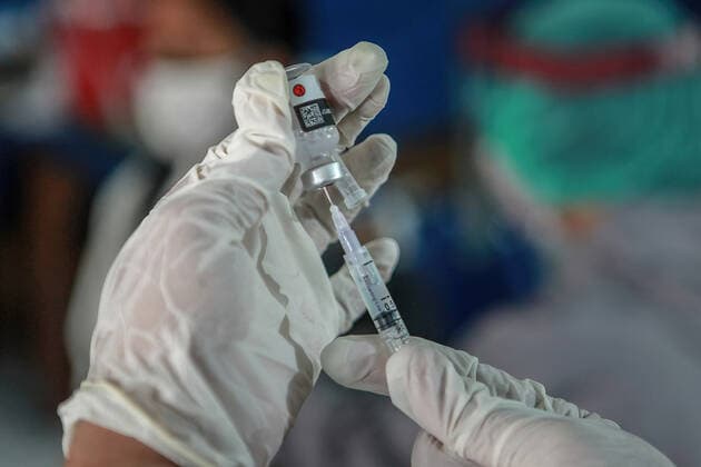July 14, 2021, Malang, Indonesia: A health worker prepares to administer a COVID-19 vaccine to a child at Naval Base in Malang..The Indonesian Ministry of Health has started to roll out Phase Three Vaccinations for Vulnerable People, Other General People, and Children aged 12-17 years. Malang Indonesia - ZUMAs197 20210714_zaa_s197_009 Copyright: xBayuxNovantax