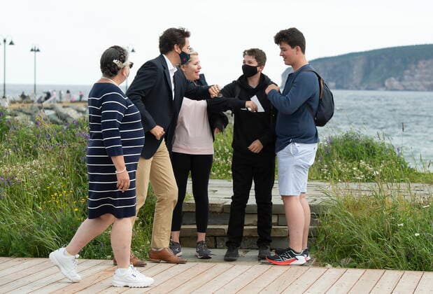 July 14, 2021, PERCE, PQ, Canada: Prime Minister Justin Trudeau, second left, greets tourists as he takes a stroll on the boardwalk near the Perce rock with Minister of National Revenue Diane Lebouthillier, left, following a meeting on Wednesday, July 14, 2021 in Perce, Quebec. PERCE Canada  - ZUMAc35_ 20210714_zaf_c35_007 Copyright: xJacquesxBoissinotx