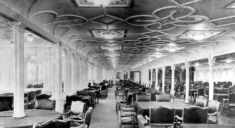 RMS Titanic was a British passenger liner that sank in the North Atlantic Ocean in the early morning of 15 April 1912, after colliding with an iceberg during her maiden voyage from Southampton to New York City.<br ><br > Of the 2,224 passengers and crew aboard, more than 1,500 died in the sinking, making it one of the deadliest commercial peacetime maritime disasters in modern history. The largest ship afloat at the time it entered service, the RMS Titanic was the second of three Olympic class ocean liners operated by the White Star Line, and was built by the Harland and Wolff shipyard in Belfast. UK: RMS Titanic, The First Class Dining Room, c. 1912 xSupplier:xCPAxMediaxCo.xLtd.x Copyright: xx