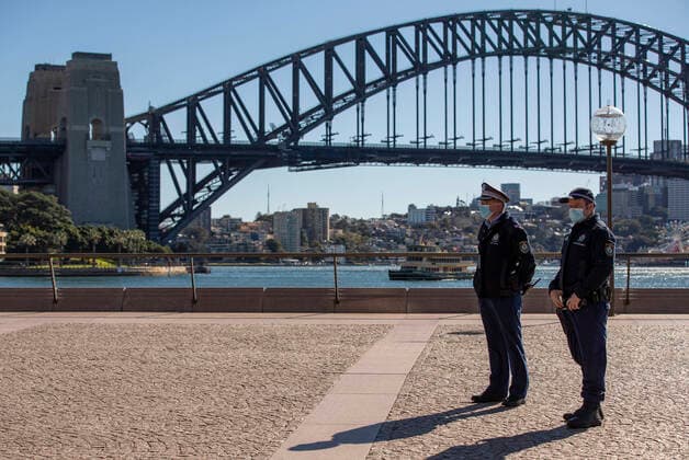 (210718) -- SYDNEY, July 18, 2021 -- Police officers are seen near Harbour Bridge in Sydney, Australia, July 18, 2021. Rising COVID-19 cases sparked tougher restrictions with more retail closed in Australia s state of New South Wales (NSW), the epicenter of the country s current outbreak, on Saturday. ) AUSTRALIA-SYDNEY-LOCKDOWN BaixXuefei 
