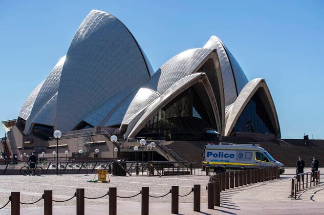 (210718) -- SYDNEY, July 18, 2021 -- A police vehicle is seen near Sydney Opera House in Sydney, Australia, July 18, 2021. Rising COVID-19 cases sparked tougher restrictions with more retail closed in Australia s state of New South Wales (NSW), the epicenter of the country s current outbreak, on Saturday. ) AUSTRALIA-SYDNEY-LOCKDOWN BaixXuefei 