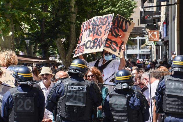 July 17, 2021, Marseille, France: A protester holds a placard infront of police during the demonstration against the health pass in Marseille..More than 4,000 people in Marseille demonstrated against a health pass that French President Emmanuel Macron announced among the new anti-Covid 19 measures which will be necessary to be frequenting cafÃ terraces, restaurants, cinemas, theatres and other culture and leisure activities to help contain the spread of the Covid-19 virus. Marseille France - ZUMAs197 20210717_zaa_s197_452 Copyright: xGerardxBottinox