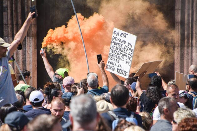 July 17, 2021, Marseille, France: Protesters hold placards and smoke flare during a demonstration against the health pass in front of town hall in Marseille..More than 4,000 people in Marseille demonstrated against a health pass that French President Emmanuel Macron announced among the new anti-Covid 19 measures which will be necessary to be frequenting cafÃ terraces, restaurants, cinemas, theatres and other culture and leisure activities to help contain the spread of the Covid-19 virus. Marseille France - ZUMAs197 20210717_zaa_s197_457 Copyright: xGerardxBottinox