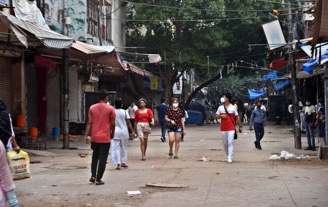 NEW DELHI, INDIA - JULY 18: People walk past the closed shops at export market in Delhi s Sarojini Nagar after it was shut down by authorities for violating Covid-19 protocols, on July 18, 2021 in New Delhi, India. (Photo by Raj K Raj Hindustan Times) Shoppers Flout Covid Norms In Delhi s Sarojini Market