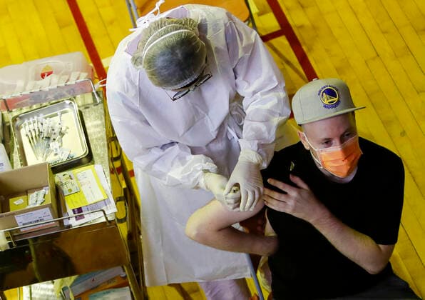 July 21, 2021, Taipei, Taipei, Taiwan: A foreigner is getting inoculated with the vaccine against the coronavirus, at a vaccination site inside National Taiwan University Hospital, as the island is discussing the possibility of lowering the Covid-19 alert to a level 2. The island has been offering AstraZeneca, Moderna and Medigrn vaccines to boost its immunity rate. Taipei Taiwan - ZUMAs313 20210721_zip_s313_007 Copyright: xDanielxCengxShou-Yix