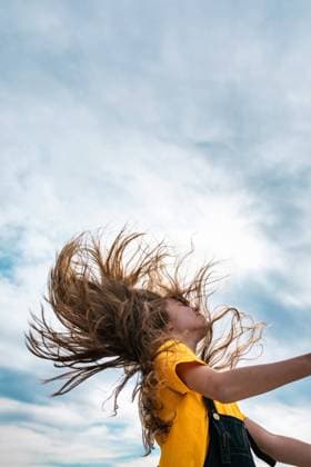 Side view from below of peaceful teenager throwing long hair on background of cloudy sky in summer, Model released SergioVictorVega_SebasKing_13.jpg Copyright: xSergioxVictorxVegax MR