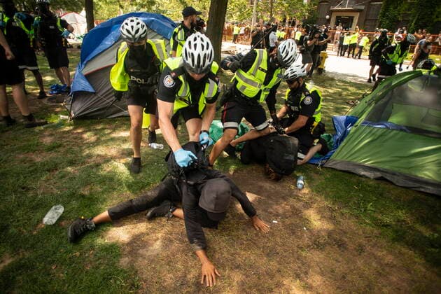 July 21, 2021, Toronto, on, Canada: Toronto police make arrests as they clear the Lamport Stadium Park encampment in Toronto on Wednesday July 21, 2021. The operation came a day after a different encampment was cleared at a downtown park. The city has cited the risk of fires and the need to make parks accessible to everyone as factors behind the clearings. Toronto Canada  - ZUMAc35_ 20210721_zaf_c35_010 Copyright: xChrisxYoungx