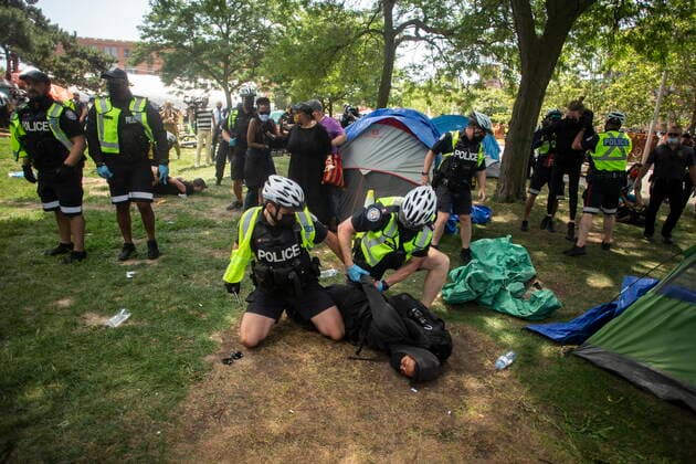 July 21, 2021, Toronto, on, Canada: Toronto police detain encampment supporters as they clear the Lamport Stadium Park encampment in Toronto on Wednesday July 21, 2021. The operation came a day after a different encampment was cleared at a downtown park. The city has cited the risk of fires and the need to make parks accessible to everyone as factors behind the clearings. Toronto Canada  - ZUMAc35_ 20210721_zaf_c35_013 Copyright: xChrisxYoungx