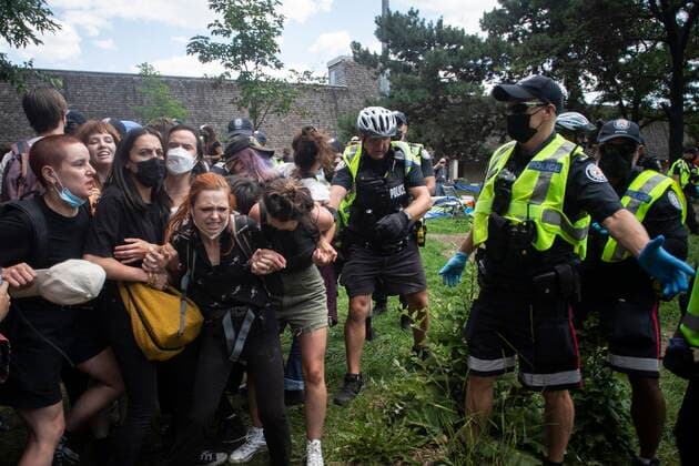 July 21, 2021, Toronto, on, Canada: Toronto police remove encampment supporters as they clear the Lamport Stadium Park encampment in Toronto on Wednesday July 21, 2021. The operation came a day after a different encampment was cleared at a downtown park. The city has cited the risk of fires and the need to make parks accessible to everyone as factors behind the clearings. Toronto Canada  - ZUMAc35_ 20210721_zaf_c35_017 Copyright: xChrisxYoungx