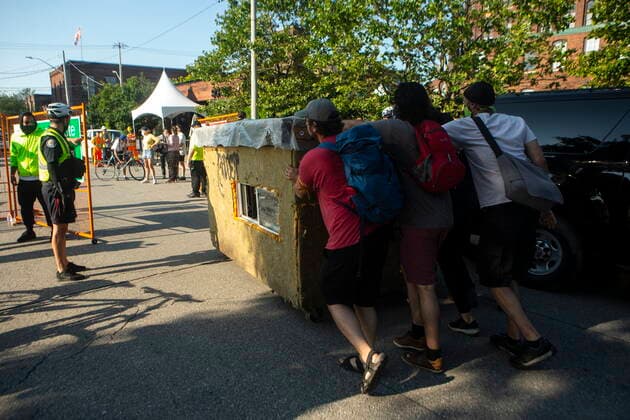 July 21, 2021, Toronto, on, Canada: Encampment supporters push a tiny shelter outside a fenced cordon as they prepare for police and city workers to clear the Lamport Stadium Park homeless encampment in Toronto on Wednesday, July 21, 2021. Toronto Canada  - ZUMAc35_ 20210721_zaf_c35_040 Copyright: xChrisxYoungx