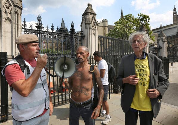July 21, 2021, London, United Kingdom: Former soldier Nick Trotsky, wearing an elite forces beret speaks through a megaphone, during the demonstration..English weather forecaster, businessman, activist, Piers Corbyn with other protesters met outside the House of Commons at Parliament Square to protest against Vaccine passports and other Coronavirus restrictions that he feels the public are being softened up to accept as the new normal. London United Kingdom - ZUMAs197 20210721_zaa_s197_206 Copyright: xMartinxPopex