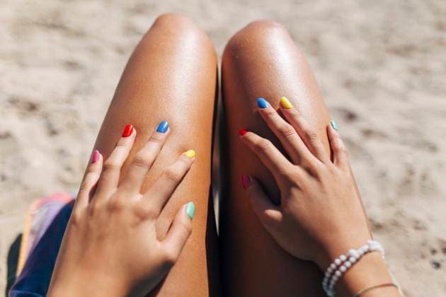Woman with colorful nail polish enjoying sunny day at beach model released Symbolfoto EGHF00077
