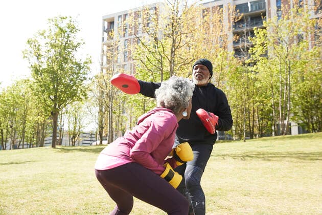 IMAGO Creative: Sport in der Stadt Couple practicing boxing at park on sunny day model released Symbolfoto PMF01989