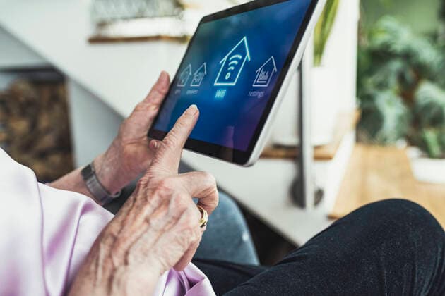 Woman connecting digital tablet with wifi at home model released Symbolfoto property released UUF23666