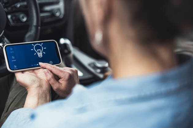 Woman using mobile phone while sitting in car model released Symbolfoto property released UUF23731