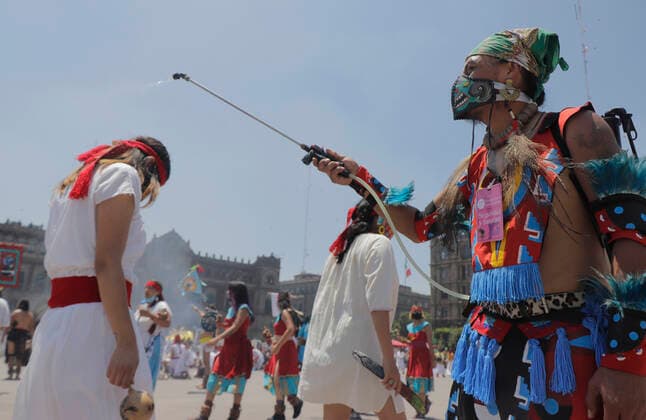 696th Anniversary Of The Founding Of Tenochtitlan A pre-hispanic dancer sanitizes her partners during the 696th anniversary of the founding of Tenochtitlan, the Mexican capital, an event held in the Zocalo of Mexico City, where musicians, singers, healers and creators of offerings from various traditions of Mexico, shared their knowledge and honoured their ancestors on the occasion of the Zenithal Passage, the moment when the Sun took a totally perpendicular position. Mexico City Mexico vieyra-notitle210726_npTa3  Copyright: xGerardoxVieyrax