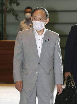Japan PM Suga Japanese Prime Minister Yoshihide Suga arrives at his office in Tokyo on July 29, 2021. The country s daily total of COVID-19 cases topped 10,000 for the first time the same day.  A14AA0000755088P