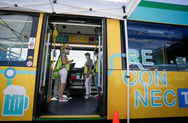 (210730) -- DELTA (CANADA), July 30, 2021 -- Healthcare workers are seen on a COVID-19 vaccine bus at Tsawwassen Ferry Terminal in Delta, British Columbia, Canada, on July 30, 2021. The vaccine bus is part of Vax for B.C. campaign in British Columbia aimed at boosting up the vaccination rate. (Photo by Xinhua) CANADA-DELTA-COVID-19-VACCINE BUS LiangxSen 