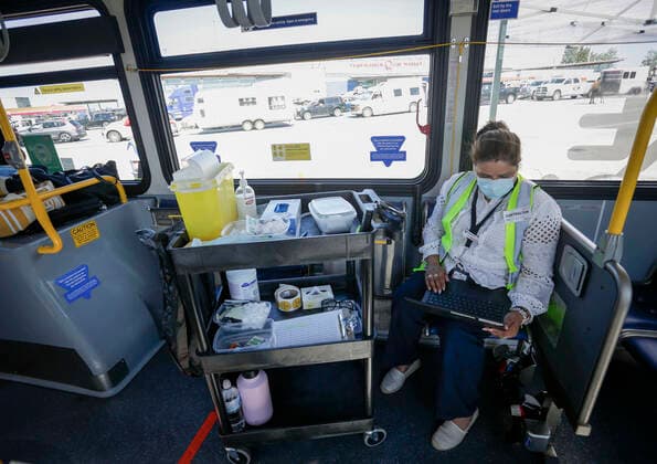 (210730) -- DELTA (CANADA), July 30, 2021 -- A healthcare worker is seen on a COVID-19 vaccine bus at Tsawwassen Ferry Terminal in Delta, British Columbia, Canada, on July 30, 2021. The vaccine bus is part of Vax for B.C. campaign in British Columbia aimed at boosting up the vaccination rate. (Photo by Xinhua) CANADA-DELTA-COVID-19-VACCINE BUS LiangxSen 