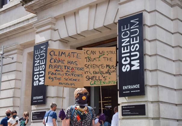 July 31, 2021, London, United Kingdom: A demonstrator holds placards expressing her opinion outside the Science Museum entrance during the anti-Shell sponsorship protest..Extinction Rebellion activists gathered once again outside the museum in South Kensington as part of their ongoing protest against oil giant Shell s sponsorship of the Our Future Planet climate change exhibition. London United Kingdom - ZUMAs197 20210731_zaa_s197_077 Copyright: xVukxValcicx