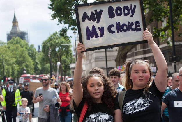July 31, 2021, London, United Kingdom: Children hold a placard that says My body my choice during the demonstration..Children and their parents protest in Central London against continued Covid-19 restrictions and vaccination of children. London United Kingdom - ZUMAs197 20210731_zaa_s197_279 Copyright: xMartinxPopex
