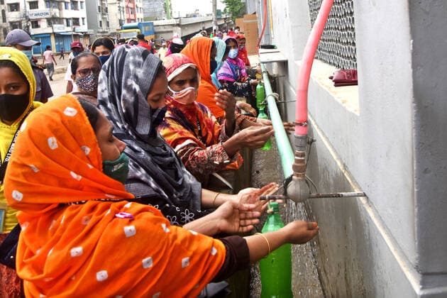 Economy In Bangladesh Garment workers wash their hands as a preventive measure Against Covid-19 Coronavirus before entering a Garment factory after garment factories reopened during Covid-19 lockdown in Dhaka, Bangladesh, on August 1, 2021. Dhaka Bangladesh rashid-garments210801_npOhs  Copyright: xSTRx