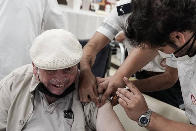 August 2, 2021, Jerusalem, Israel: Paramedics from Magen David Adom, serving as the Israeli Red Cross organization and leading EMS, deliver a 3rd BioNTech Pfizer booster vaccine to seniors at the Mishan Gonen Assisted Living Residence for the elderly. PM Bennett announced his goal of vaccinating all Israeli seniors, 60 and above, with a 3rd vaccine by the end of August 2021, in spite of the fact that a booster shot has not yet been approved by the US FDA. Jerusalem Israel - ZUMAa126 20210802_zap_a126_020 Copyright: xNirxAlonx