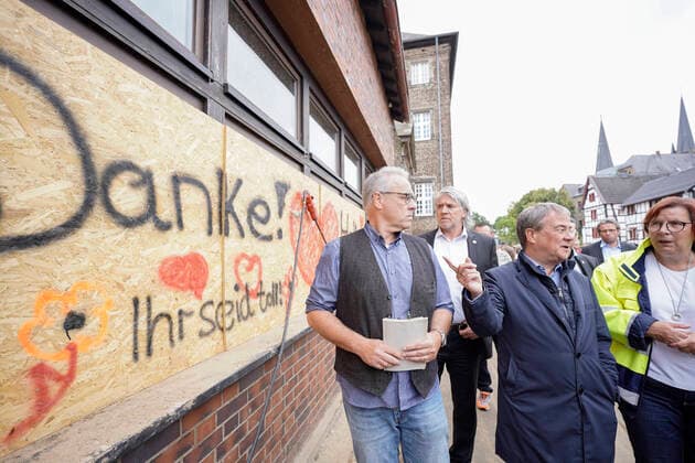 News Bilder des Tages Ministerpraesident von NRW Armin Laschet besucht die vom Unwetter betroffenen Orte Swisttal Aktuell, 02.08.2021, Swisttal-Odendorf (Rhein-Sieg-Kreis), Ministerpraesident von Nordrhein-Westfalen, Kanzlerkandidat und CDU-Vorsitzenden Armin Laschet gemeinsam mit Buergermeisterin Petra Kalkbrenner vor Ort in den von Unwetter betroffenen Gemeinde Swisttal um sich ein aktuelles Bild von den Schaeden und den Aufraeumarbeiten zu machen. - Armin Laschet geht an einem Schild vorbei mit der Aufschrift Danke ihr seid toll Swisttal Nordrhein-Westfalen Deutschland