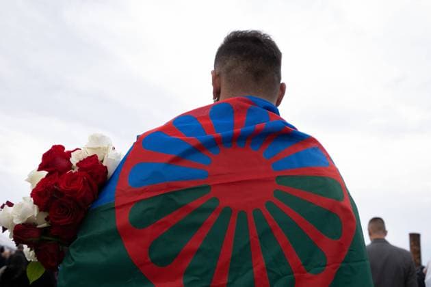 August 2, 2021, Brzezinka, Poland: A Gypsy seen stands while holding flowers at the former camp Auschwitz II Birkenau..Roma and Sinti Genocide Remembrance Day. 77 years ago, on the night of 2 to 3 August 1944, the Germans liquidated the camp for Gypsies (Zigeunerfamilienlager) in KL Auschwitz II Birkenau. The anniversary was organized at the former camp Auschwitz II-Birkenau. Brzezinka Poland - ZUMAs197 20210802_zaa_s197_096 Copyright: xWojciechxGrabowskix