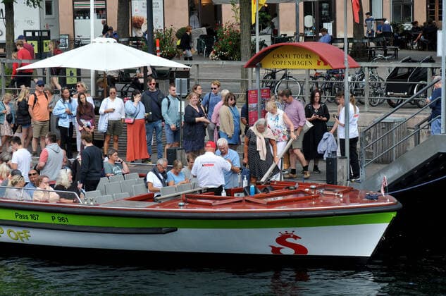Copenhagen, Denmark., 04 August 2021,Visitors boardding on canal tour baot crusing baot in danish capital Copenhagen. (Photo..Francis Joseph Dean Dean Pictures)