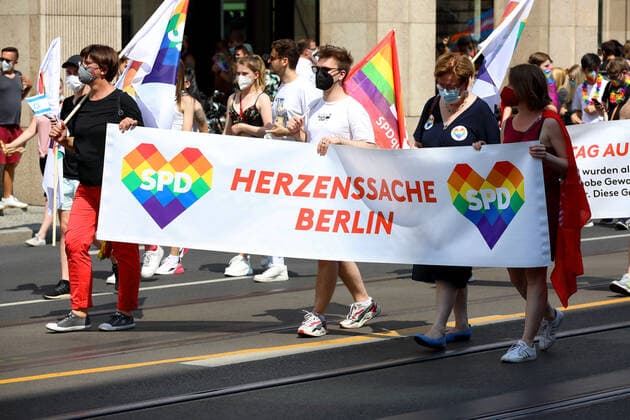 Berliner CHRISTOPHER STREET DAY 2021 - CSD - Am 24. Juli 2021 zieht der CSD in Berlin unter dem Motto SAVE OUR COMMUNITY SAVE YOUR PRIDE zum 43. Mal durch die Hauptstadt. Saskia Esken (Parteivorsitzende der SPD) trägt Banner mit Regenbogenfarben und der Aufschrift: HERZENSSACHE BERLIN - SPD Die bunte CSD-Parade startete in diesem Jahr als Demonstration an der Leipziger Straße, führte über den Potsdamer Platz, vorbei am Denkmal für die im Nationalsozialismus verfolgten Homosexuellen zum Brandenburger Tor und über die Siegessäule zur Urania. Aufgrund der Corona-Pandemie fand die Demonstration ausschließlich unter Einhaltung der vom Berliner Senat erlassenen Vorgaben statt. Die in den Vorjahren übliche Abschlusskundgebung musste