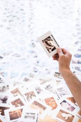 Arm of man holding photographic slide of two naked women model released Symbolfoto property released SKAF00144