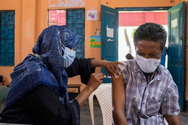 Bangladesh begins nationwide Covid-19 vaccination drive A healthcare worker injects a man with Moderna Covid-19 Vaccine. Dhaka Bangladesh Lalmatia Copyright: RizwanxHasan