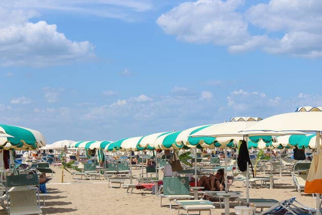 August 6, 2021, Rimini, Italy: Green pass doesn t stop Ferragosto, the Italians mid-August vacation on the beaches. In Rimini and Rivieira Romanhola region, the coast is starting to get crowded even with the green certificate being mandatory. And there are many tourists arriving in the city. Since the 6th of August, the Green Pass is mandatory in Italy. Green Pass is mandatory only to enter some closed places, such as restaurants and bars, if you intend to sit and eat at the table, but also in discos, museums, exhibitions, gyms, swimming pools, amusement parks, parties and health centers. The Government extended the mandatory green pass also for access to long-distance trains and planes.  Copyright: xJosixDonellix